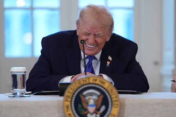 President Donald Trump laughs during a meeting with oil executives in the East Room of the White House on Friday.