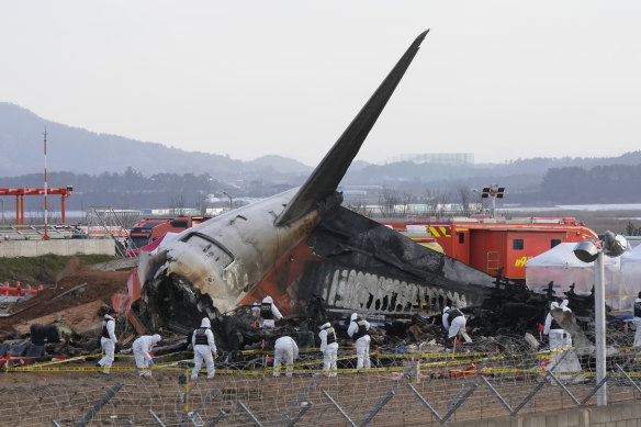 Rescue crews work at the site of the plane crash at Muan International Airport in Muan, South Korea.