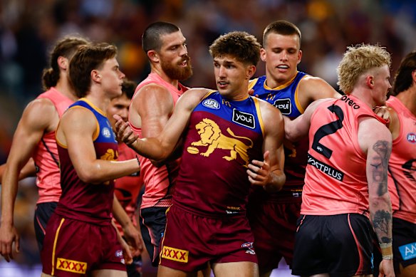 Lions and Suns players grapple, with Zac Bailey in the middle of the action.