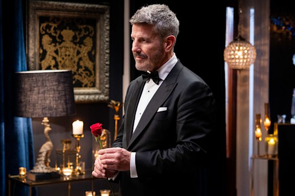 Barry “Bear” Myrden prepares to present a rose in the Golden Bachelor’s first rose ceremony