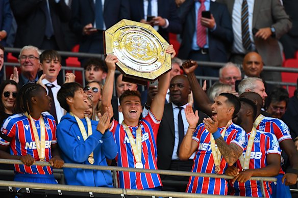 Justin Devenny lifts the FA Community Shield after his team’s victory.