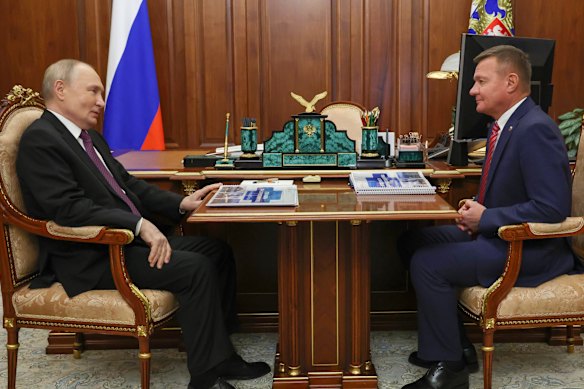 Russian President Vladimir Putin, left, with then transport minister Roman Starovoit at the Kremlin in January.