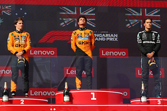 Race winner Lando Norris (centre), second placegetter Oscar Piastri (left) and third-placed George Russell (right).