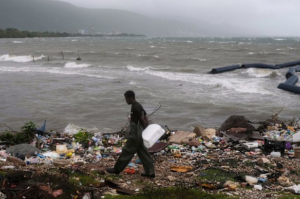 A man walks along the coastline during the passing of Hurricane Melissa in Kingston, Jamaica.