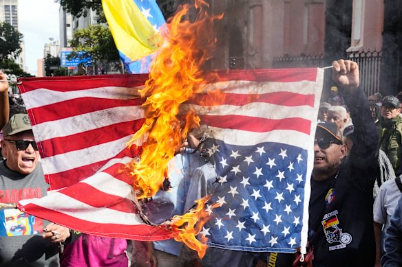 Maduro supporters burn a US flag in the Venezuelan capital, Caracas, after the US attack. 