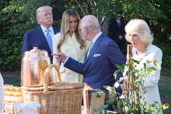 Donald and Melania Trump and King Charles and Queen Camilla look at a display on the South Lawn of the White House.