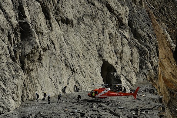 A helicopter drops search and rescue teams at the exit tunnel of the Chilime Hydropower Plant during the week.