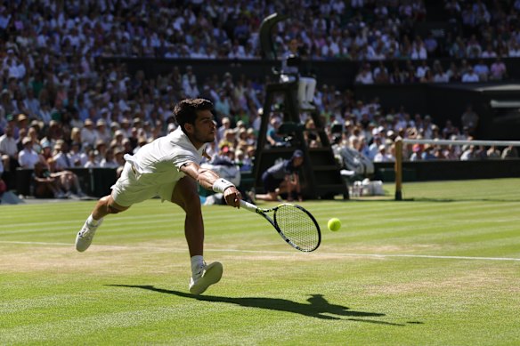 Alcaraz lunges for a forehand in his four-set semi-final victory over Fritz at Wimbledon.