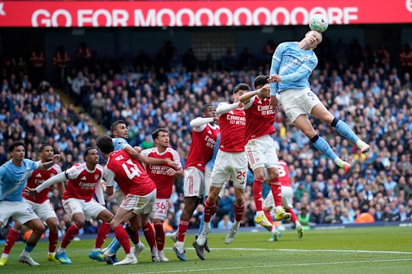 Erling Haaland heads the ball during the English Premier League soccer match between Manchester City and and Arsenal, in Manchester.