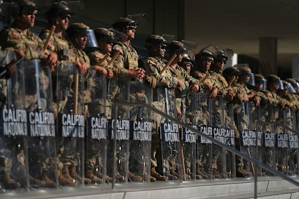 California National Guard form a line outside the Federal Building in downtown LA on Tuesday. 