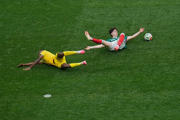 South African Sphephelo “Yaya” Sithole (yellow) was given a red card for this challenge on Mexico’s Brian Gutierrez.