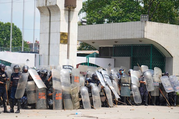 Riot police stand guard outside the parliament.
