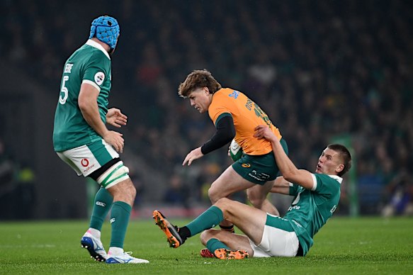 James O’Connor of Australia is tackled by Sam Prendergast.