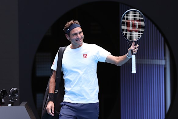 Roger Federer walks onto Rod Laver Arena for a practice session with Casper Ruud.