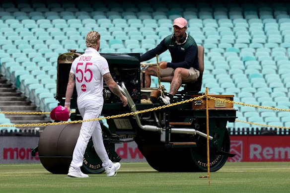 SCG curator Adam Lewis chats with England captain Ben Stokes as he prepares the pitch on Friday.