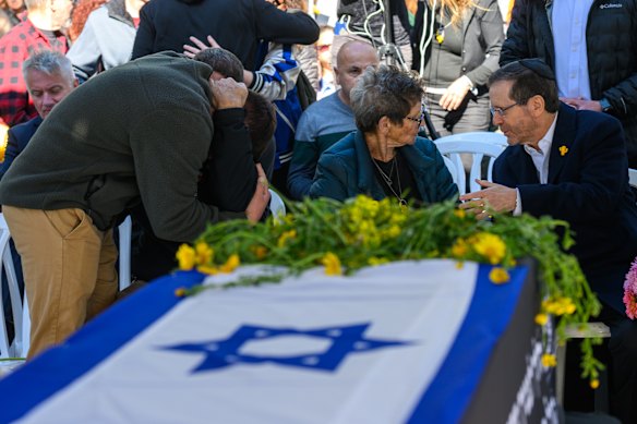 Yocheved Lifshitz talks to Israeli President Issac Herzog during the funeral for her husband Oded Lifshitz in Nir Oz, Israel. The body of former Israeli hostage Oded Lifshitz was returned to Israel from Gaza on Thursday.