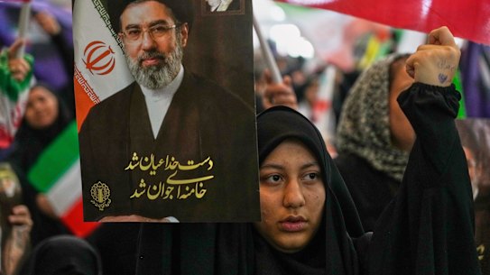 An Iranian woman carries a portrait of Supreme Leader Mojtaba Khamenei. Instead of being toppled, the regime appears to have further entrenched its position following the US-Israeli attack.