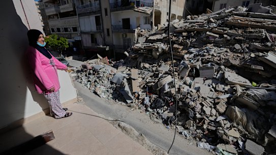 A woman looks through her damaged apartment that was hit a few weeks ago by an Israeli air strike in the southern city of Tyre.