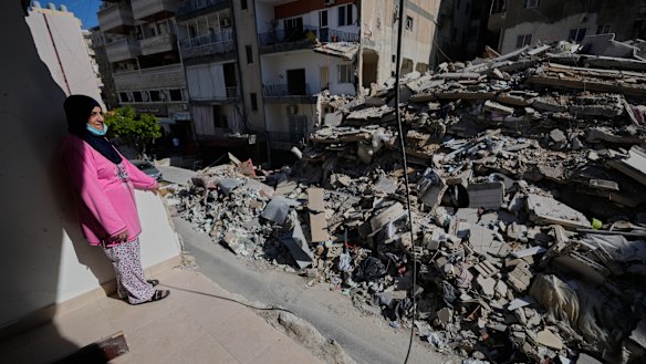 A woman looks through her damaged apartment that was hit a few weeks ago by an Israeli air strike in the southern city of Tyre.