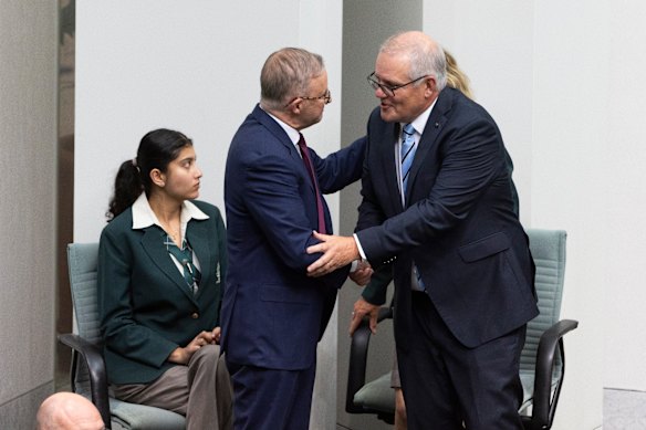 Prime Minister Anthony Albanese and former Prime Minister Scott Morrison shake hands at Parliament House in 2024.