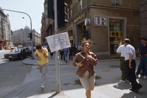 Bosnian civilians flee sniper gunshots on the streets of Sarajevo.