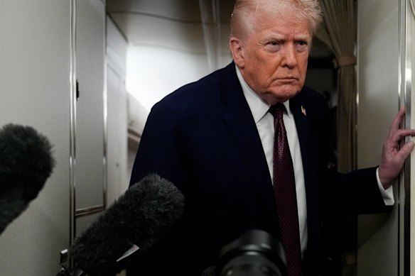 US President Donald Trump speaks to reporters while in flight on Air Force One on Sunday.