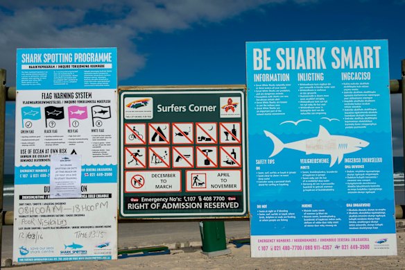 Signs alert visitors to the dangers of swimming at Muizenberg beach near Cape Town.