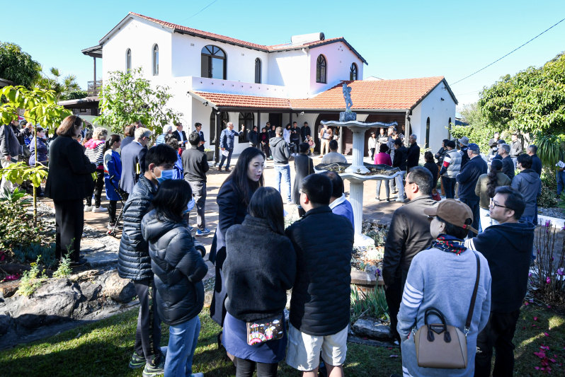 Dozens watched the five-bedroom house go under the hammer on Saturday.