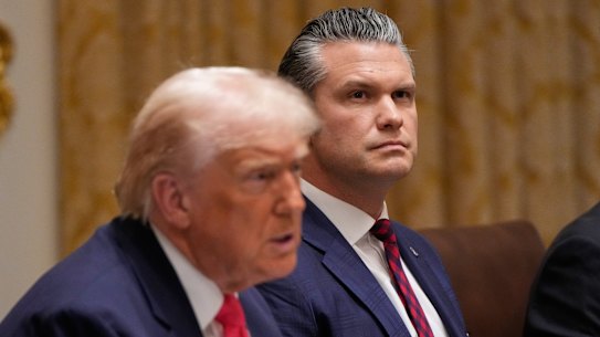 US President Donald Trump speaks during a cabinet meeting at the White House, on Tuesday as War Secretary Pete Hegseth looks on.