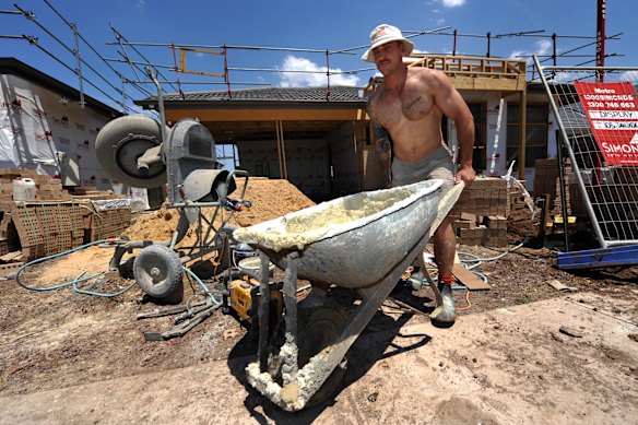  Bricklayer Nathan George on the wheelbarrow on a hot day in Melbourne.