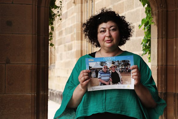 Sabina Kleitman hold a photo of father Alex and mother Larisa, taken at the Chanukah by the Sea event targeted by two gunmen on December 14. 