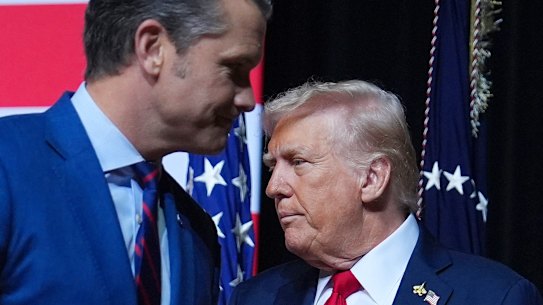 US President Donald Trump is greeted by Secretary of Defence Pete Hegseth before speaking to a gathering of top US military commanders at Marine Corps Base Quantico.
