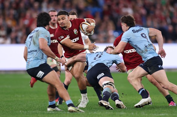 Sione Tuipulotu of the British and Irish Lions takes on the Waratahs defence.