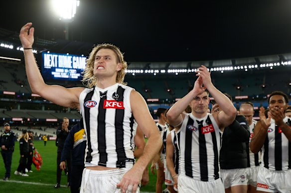 Darcy Moore and his Magpies are all smiles atop the ladder.