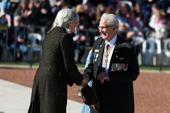 Governor-General Sam Mostyn shakes hands with veteran Ted Wilson during the Anzac Day service at the Australian War Memorial in Canberra.