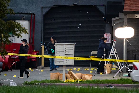 Investigators examine the scene of the mass shooting.