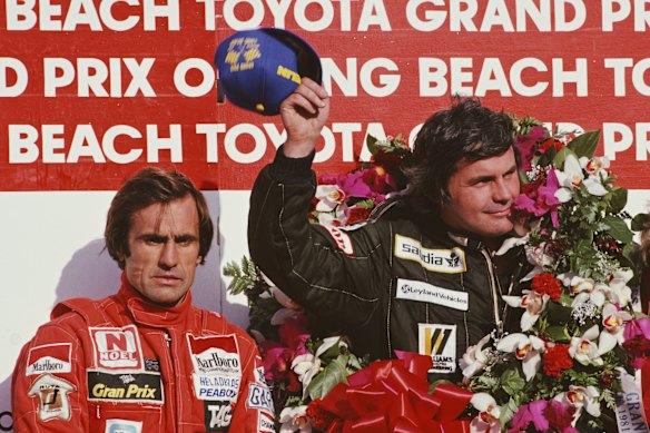 Alan Jones (right) after winning the United States Grand Prix West in 1981.
