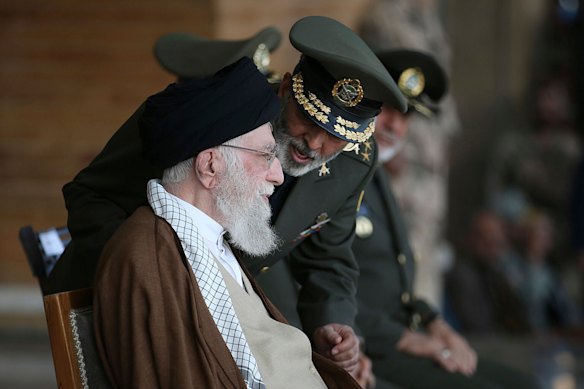 Supreme Leader Ayatollah Ali Khamenei, left, listens to army commander General Abdolrahim Mousavi during a graduation ceremony for a group of armed forces cadets in Tehran in 2023.