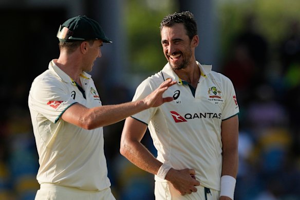 Australia’s captain Pat Cummins talks to bowler Mitchell Starc on day three of the first cricket Test match against West Indies at Kensington Stadium in Bridgetown, Barbados. 