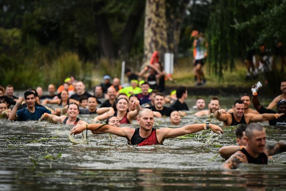 Wading chest-high through the water in Creek Crusade leg of a Tough Mudder event.