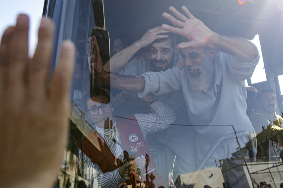 Freed Palestinian prisoners wave from a bus as they arrive in Khan Younis in the Gaza Strip after being released by Israel at the weekend.