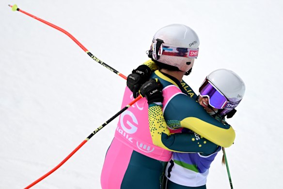 Georgia Gunew and Ethan Jackson embrace after the finish line of the giant slalom.