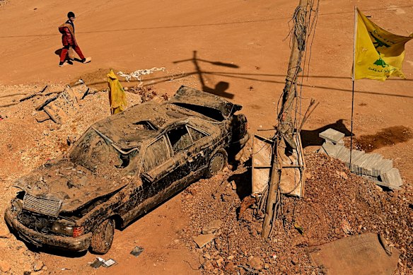 A child walks past the destruction.