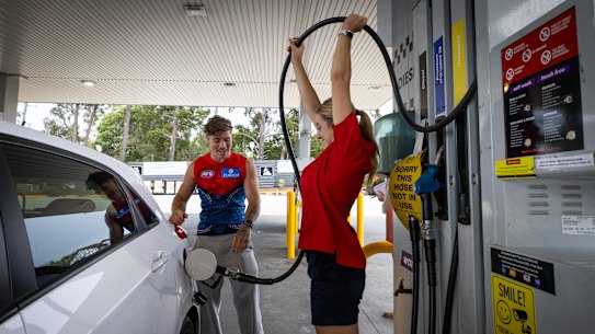 Brother and sister Jamie Roche and April Poutee find a novel way to extract the last drop of unleaded fuel from the hose.