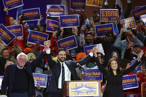 Senator Bernie Sanders, New York City mayoral candidate Zohran Mamdani, and congresswoman Alexandria Ocasio-Cortez appear on stage during a rally in New York.  