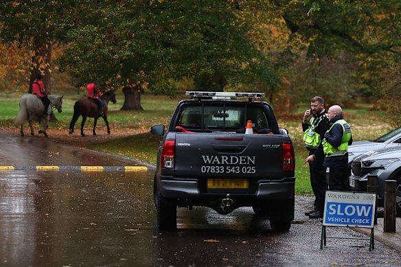 Park wardens drive through the gates to the Royal Lodge.