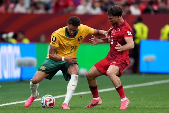 Australia’s Tete Yengi, left and Turkey’s Salih Ozcan challenge for the ball.
