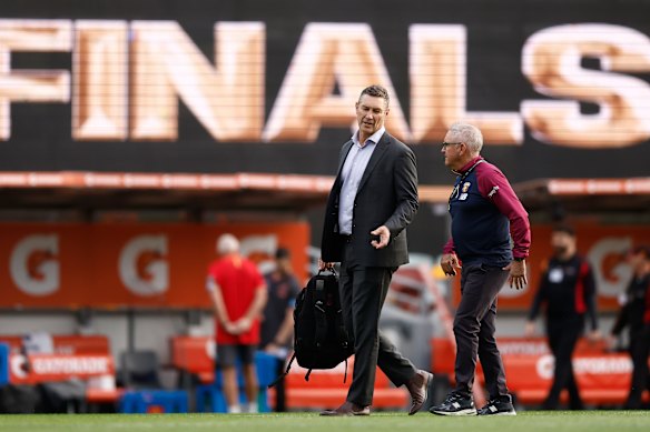 Alastair Lynch (left) and Chris Fagan, Senior Coach of the Lions chat pregame.