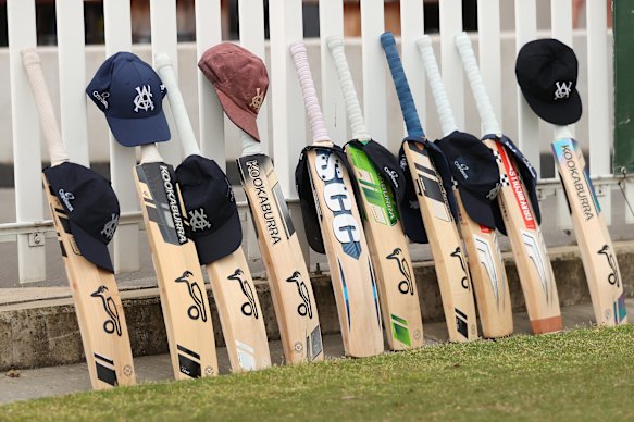 Victorian players place their bats and caps in honour of the late Ben Austin on the Junction Oval fence on Friday.