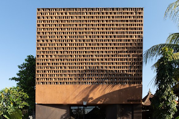 The exterior of Further Hotel is constructed with burnt sienna bricks angled and spaced to allow in air and light.